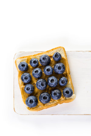 Homemade peanut butter and blueberry sandwich on white bread.の写真素材