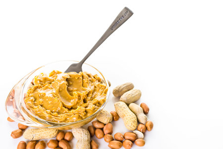 Extra chunky peanut butter on a white background.の写真素材