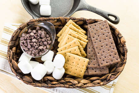 Ingredients smores dip prepared with large marshmallows in cast iron pan.の写真素材