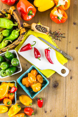Variety of fresh organic peppers on the table.の写真素材