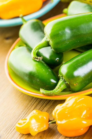 Variety of fresh organic peppers on the table.の写真素材