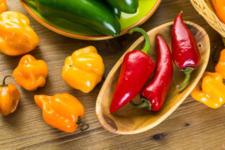 Variety of fresh organic peppers on the table.の写真素材