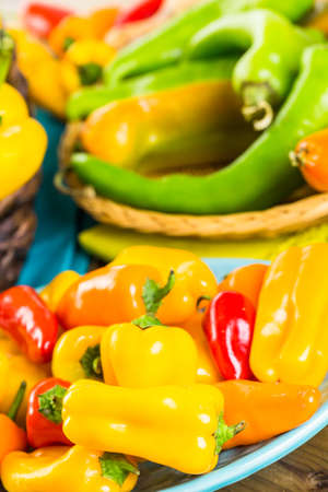 Variety of fresh organic peppers on the table.の写真素材