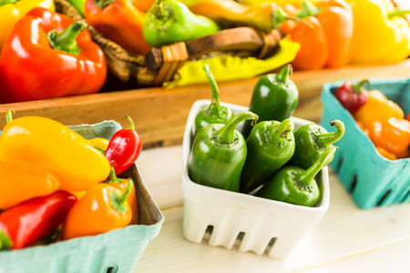 Variety of fresh organic peppers on the table.の写真素材