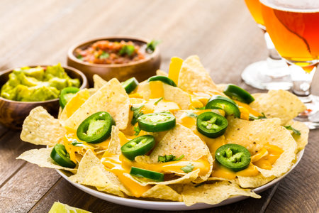 Vegetarian nachos with tortilla chips and fresh jalapeno peppers.の写真素材