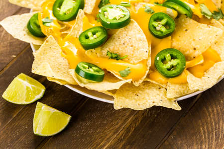 Vegetarian nachos with tortilla chips and fresh jalapeno peppers.の写真素材