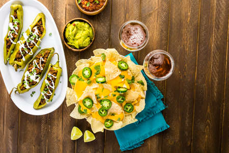 Chipotle beef & bean stuffed chile peppers garnished with sour cream and scallions.の写真素材