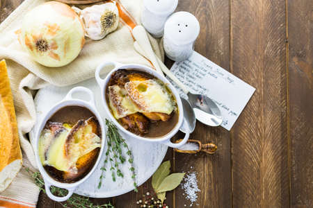 Homemade French onion soup with toasted baguette.の写真素材