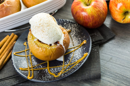 Organic baked apples served with vanilla ice cream.の写真素材