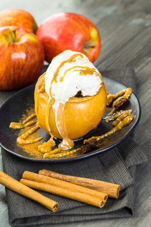 Organic baked apples served with vanilla ice cream.の写真素材