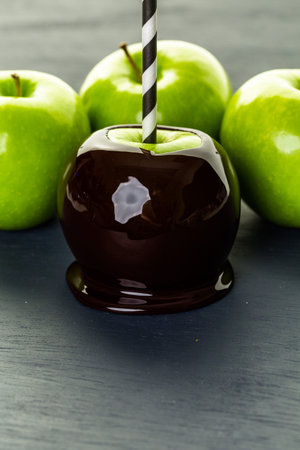 Homemade candy apples on black backgeound.の写真素材