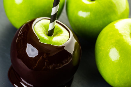Homemade candy apples on black backgeound.の写真素材
