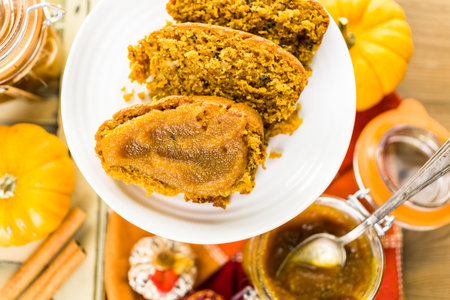 Homemade pumpkin butter with pumpking bread on the table.の写真素材
