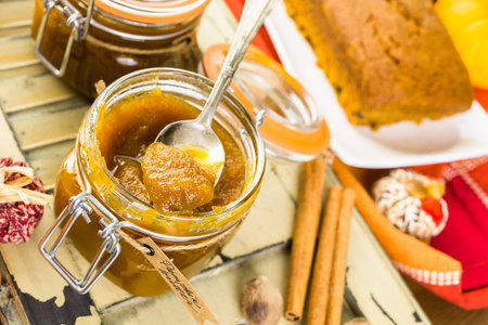Homemade pumpkin butter with pumpking bread on the table.の写真素材