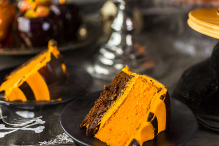 Table with colored candy apples and cake for Halloween party.の写真素材