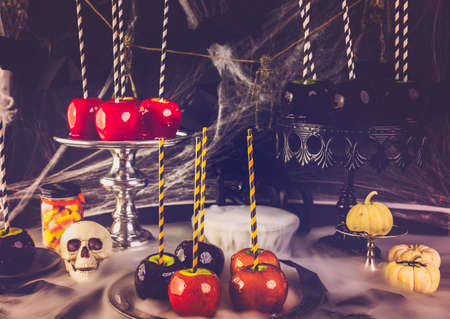 Table with colored candy apples for Halloween party.の写真素材