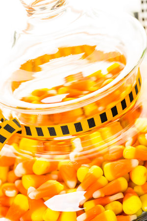 Candy corn in candy jar for Halloween treats.の写真素材