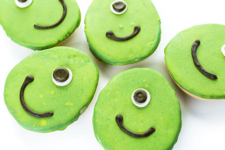 Alien cookies with green icing prepared as Halloween treats.の写真素材