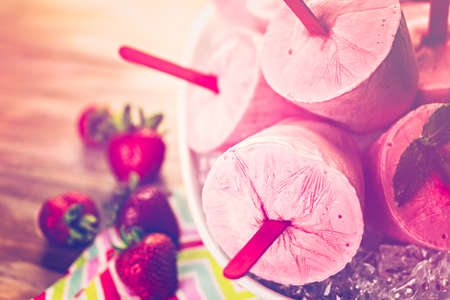 Homemade strawberry ice made in plastic cups.の写真素材