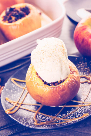 Organic baked apples served with vanilla ice cream.の写真素材
