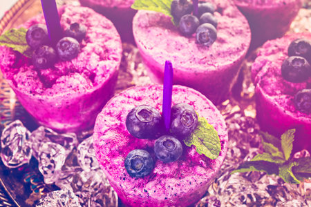 Homemade blueberry ice made in plastic cups.の写真素材