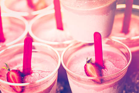 Homemade strawberry ice made in plastic cups.の写真素材