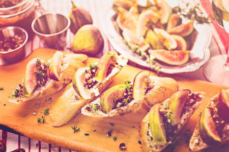 Fig bruschetta with organic California figs on cutting board.の写真素材