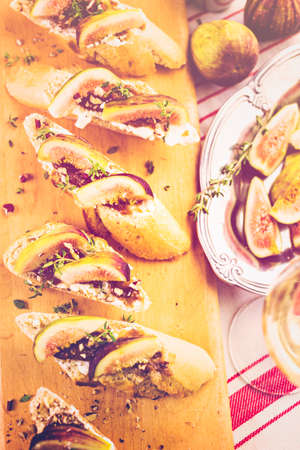 Fig bruschetta with organic California figs on cutting board.の写真素材