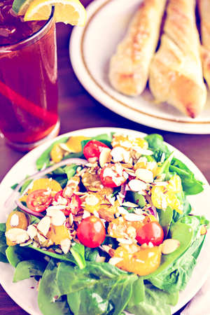 Orange spinach salad on the plate in Italian restaurant.の写真素材