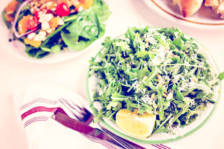 Arugula salad with pine nuts on the plate in Italian restaurant.の写真素材