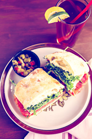 Italian sub sandwich with arugula on ciabatta bread.の写真素材