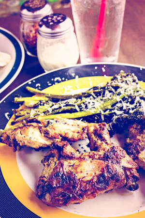 Roasted chicken with broccolini on the plate in Italian restaurant.の写真素材