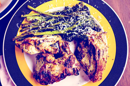 Roasted chicken with broccolini on the plate in Italian restaurant.の写真素材