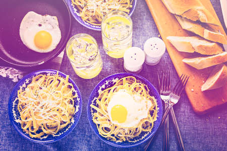 Fresh pasta pangrattato with crispy eggs on the table.の写真素材