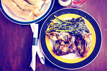Roasted chicken with broccolini on the plate in Italian restaurant.の写真素材