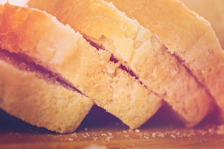 Freshly baked sourdough bread sliced on cutting board.