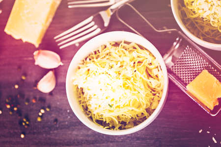 Cooking organic pasta with garlic herbs and parmesan cheese.の写真素材