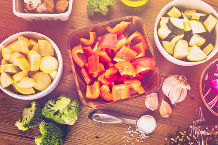 Fresh ingredients for preparing roasted mixed vegetables on the table.