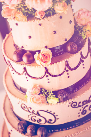 Gourmet tiered wedding cake at wedding reception.
