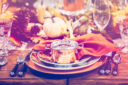 Table set with plates and silverware for Holiday dinner.