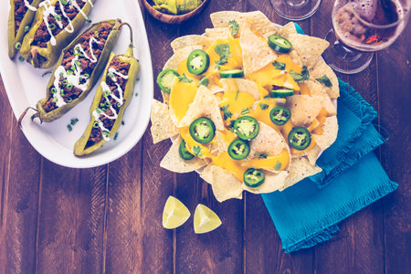 Chipotle beef & bean stuffed chili peppers garnished with sour cream and scallions.の写真素材