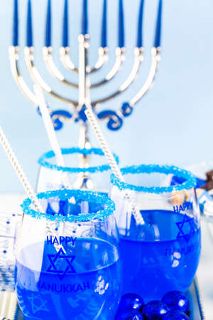 Table set with cocktails and chocolates to celebrate Hanukkah.の写真素材