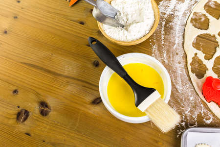 Cutting out Autumn leafs with cookie stamper to decorate pumpkin pie.の写真素材