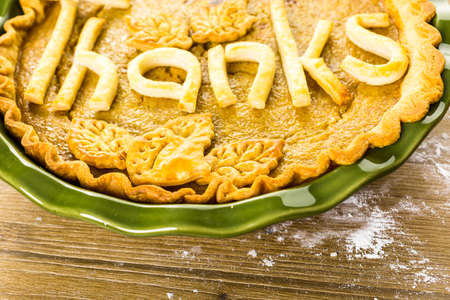 Homemade pumpkin pies with Give Thanks sign and Autumn stamped leafs.の写真素材