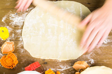 Rolling our the dough for pie crust for  pumpkin pie.の写真素材