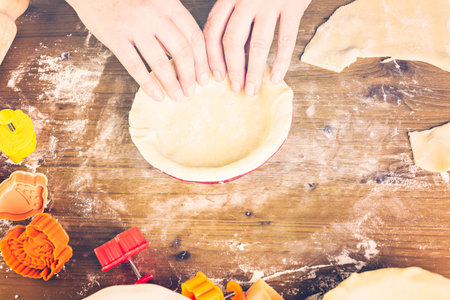 Rolling our the dough for pie crust for  pumpkin pie.の写真素材