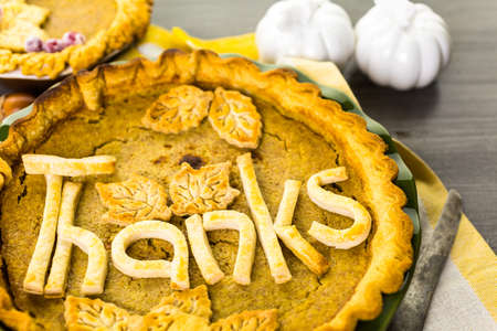 Homemade pumpkin pies with Autumn stamped leafs.の写真素材