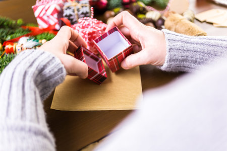 Wrapping assorted chocolates in small boxes for Christmas presents.