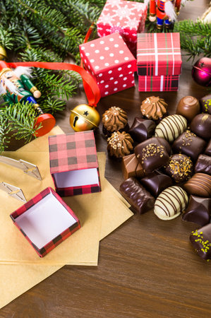 Wrapping assorted chocolates in small boxes for Christmas presents.