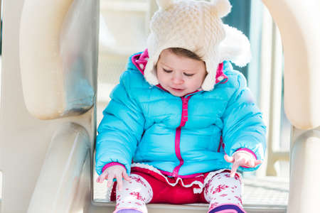 Baby girl playing on outdoor playground.の写真素材